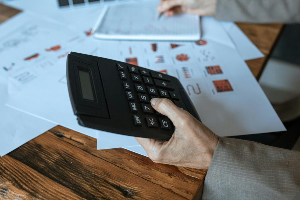 Person holding up calculator