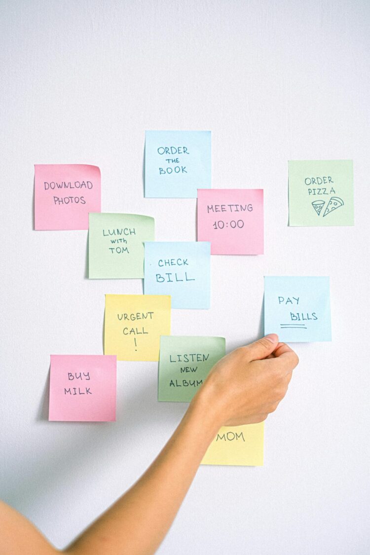 A person holding blue sticky note