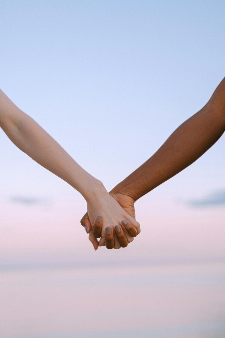 Two people holding hands