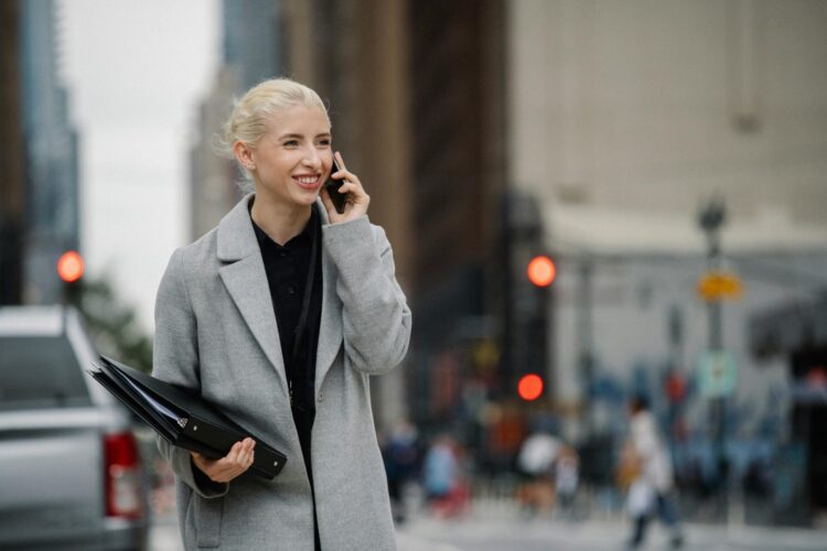 businesswoman talking on smartphone in town