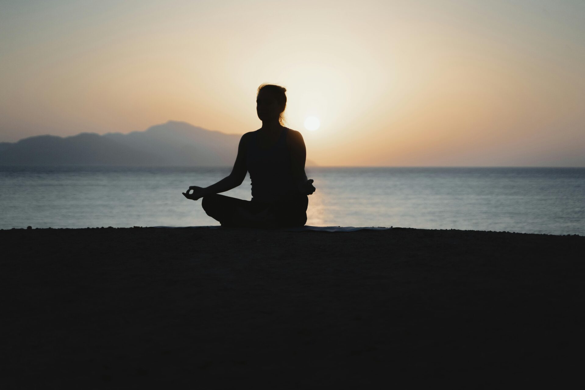 Women doing yoga on the beach