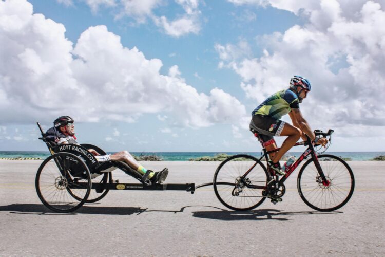 Cyclists riding bicycle on road