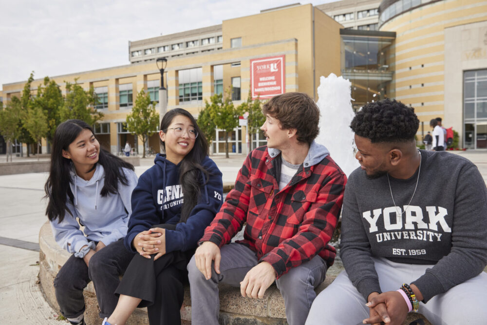 Students sitting by the fountain