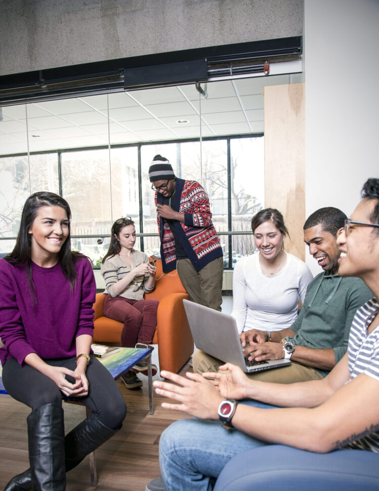 Students talking to one another and smiling