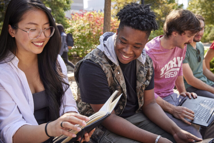 Students looking at paper smiling