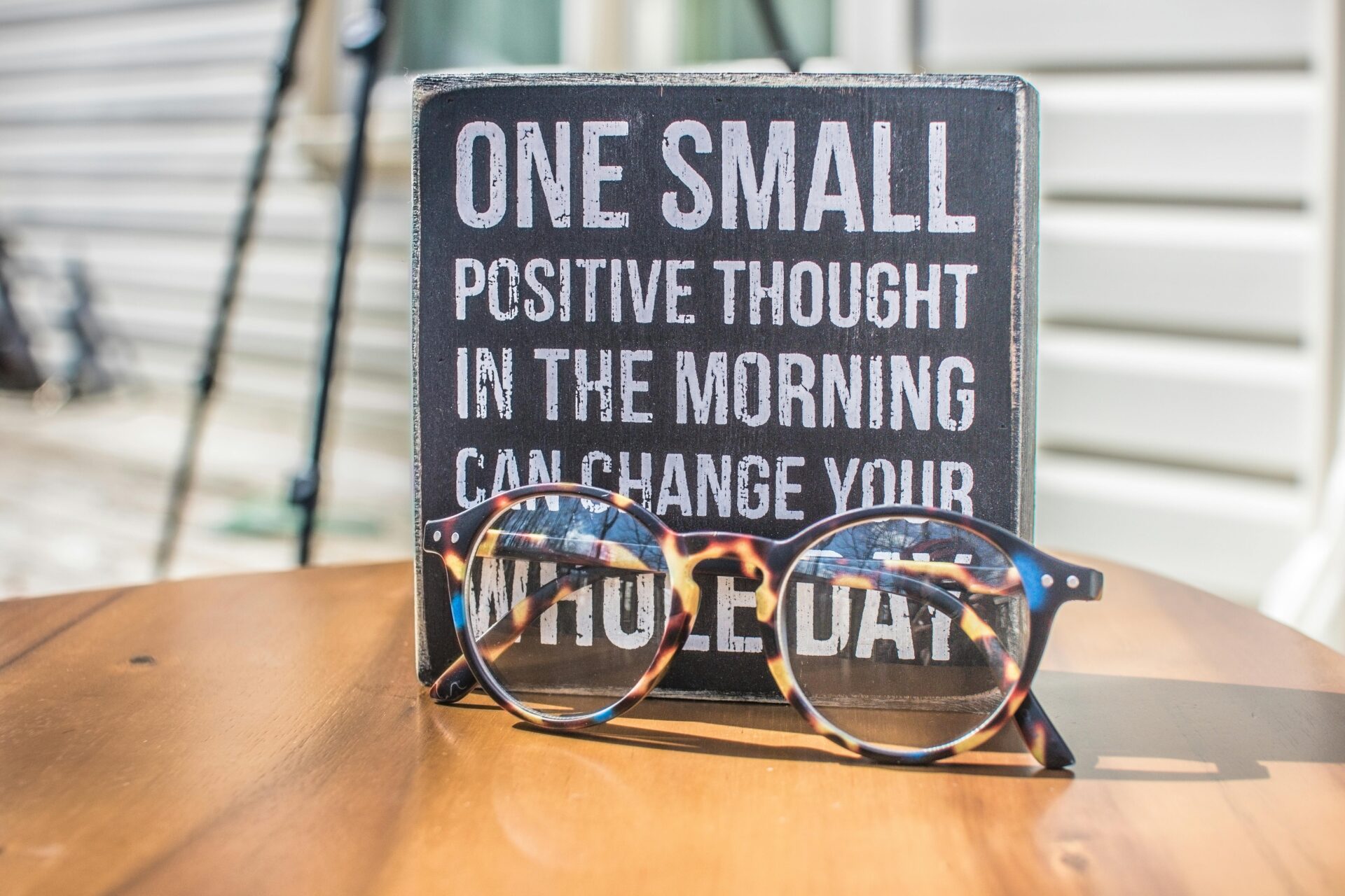 Photo of a sign and eyeglasses on table