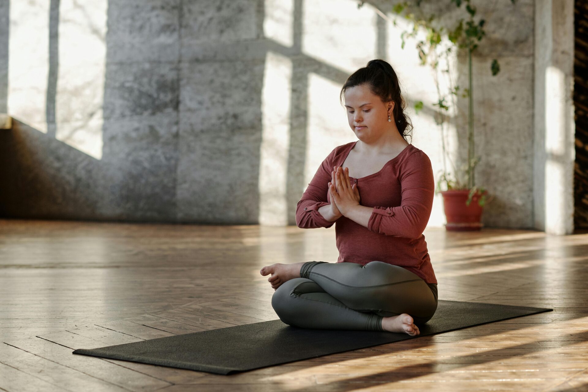 Woman meditating alone on a yoga mat