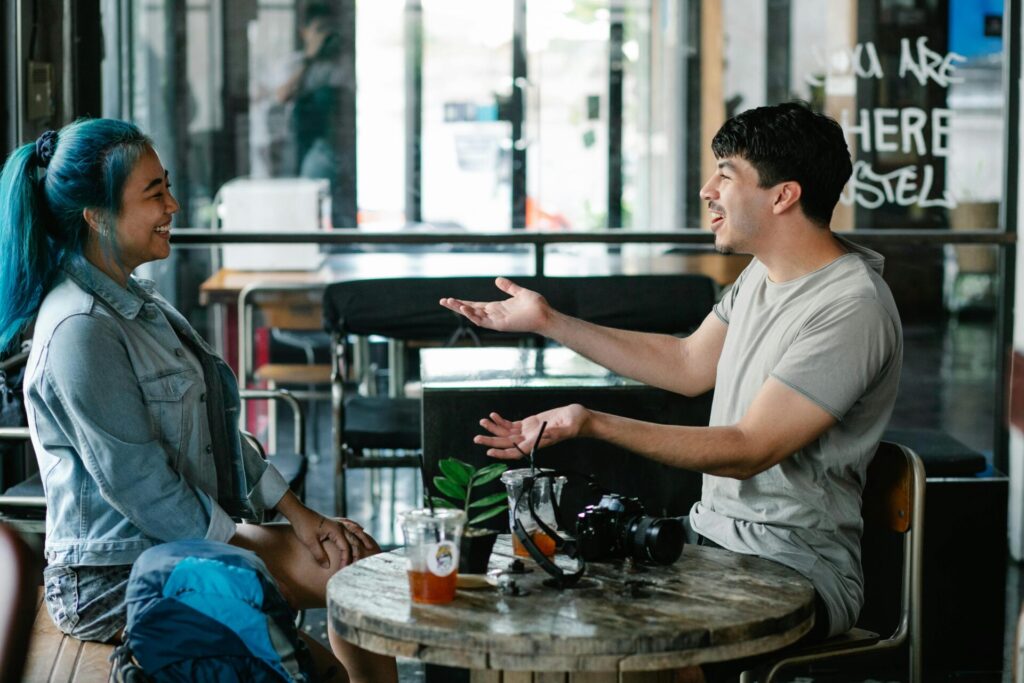 Two people sitting and chatting in cafe