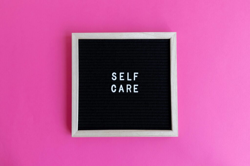 Self Care Sign on a pink background