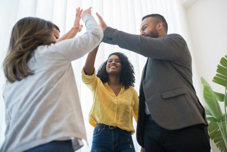 Group of men and women doing high five