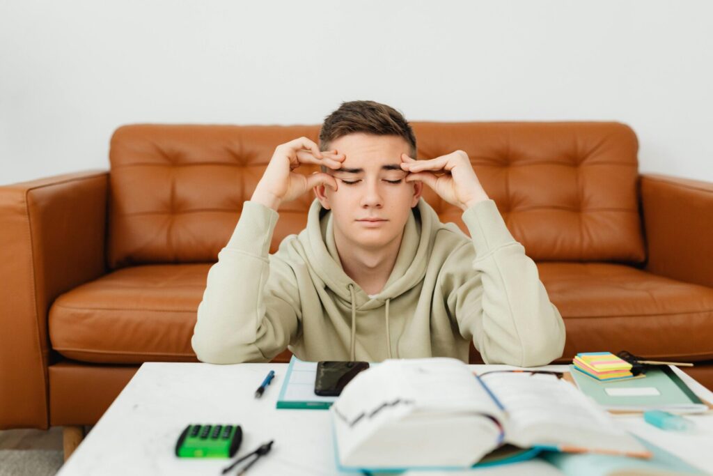 Student with his hands on his head looking frustrated