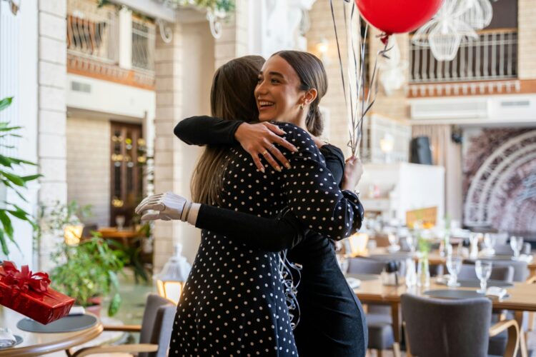 Women hugging each other happily