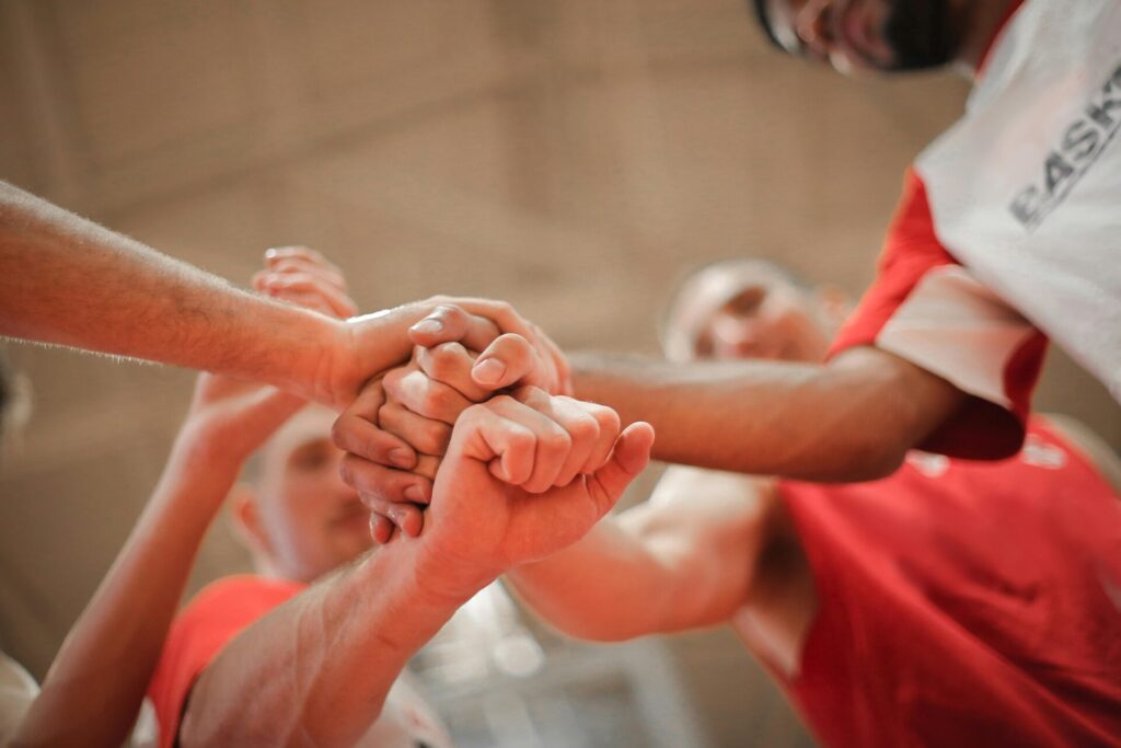 Basketball team stacking hands