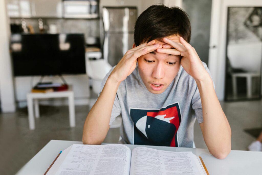 Student sitting at the table reading a book