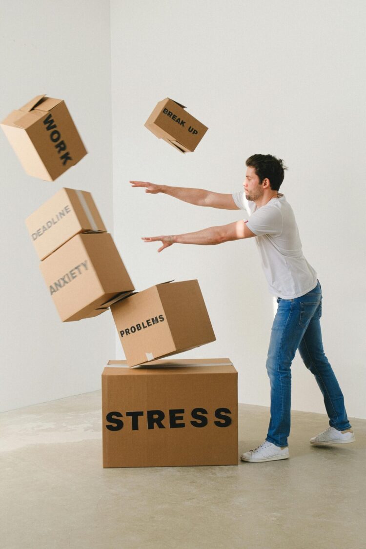 Man pushing carton boxes with negative words