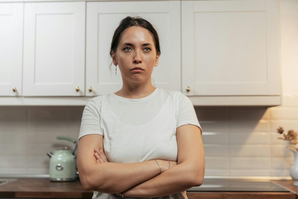 Sad Women standing in the kitchen area