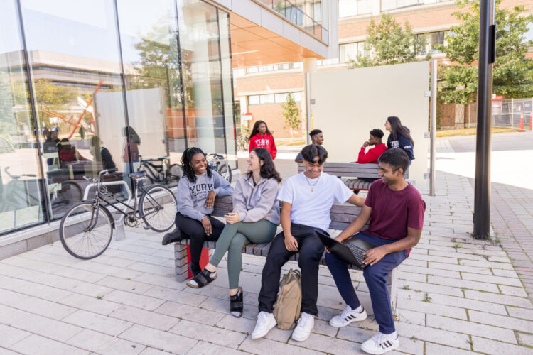 Students sitting on a bench talking