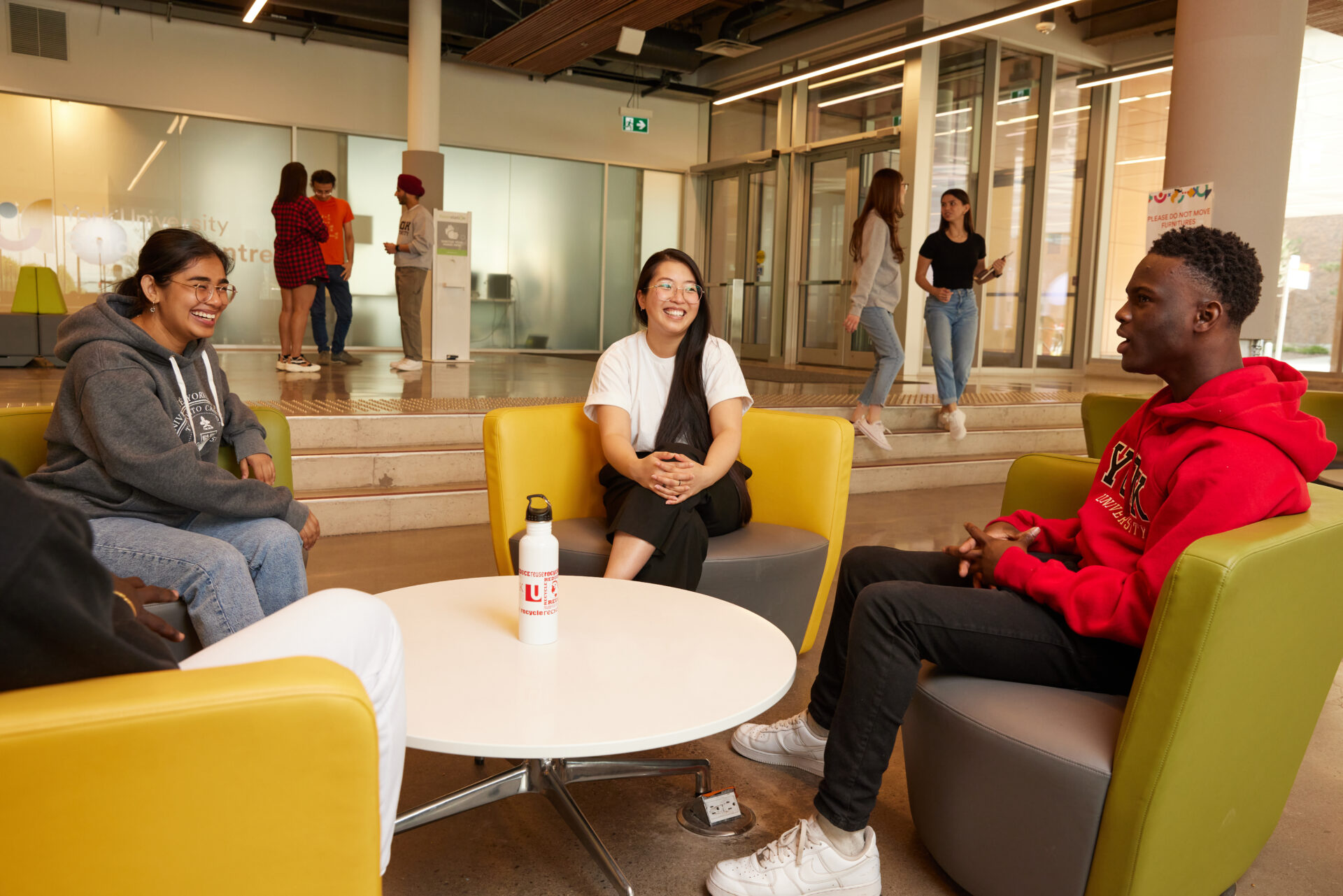 Students sitting on sofas in the lounge and talking