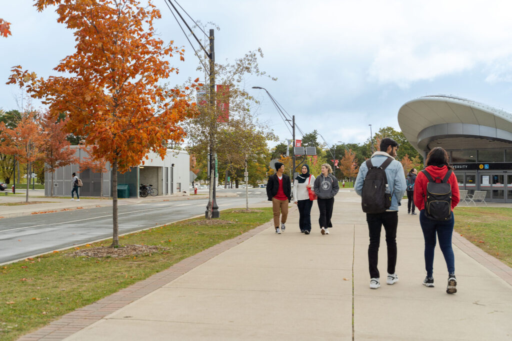 Students walking on sidewalk close to York University subway station