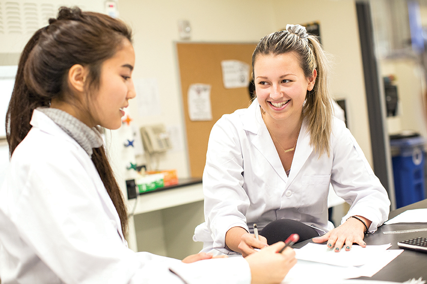 Students in a lab sitting and talking