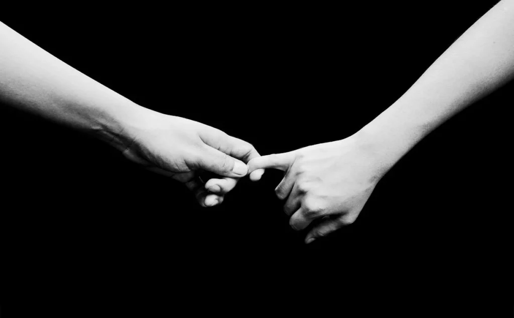 Two people holding hands