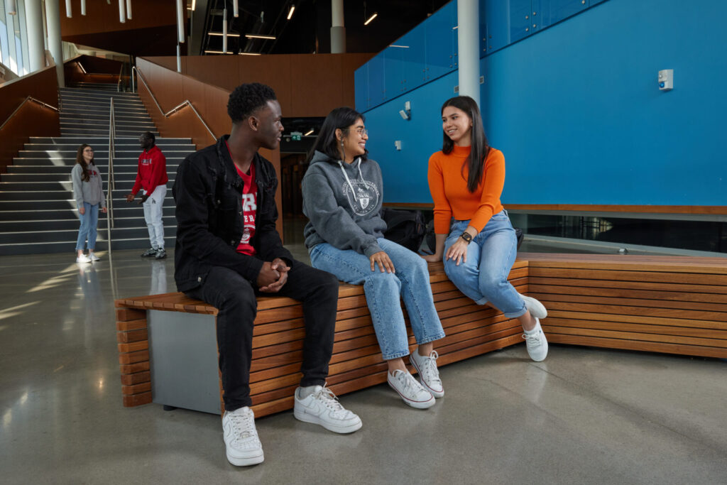 Students sitting on a bench talking