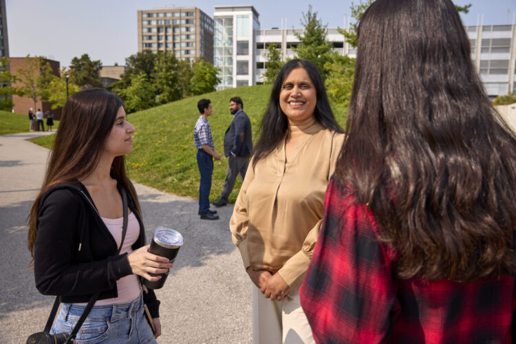 Students talking on campus walk