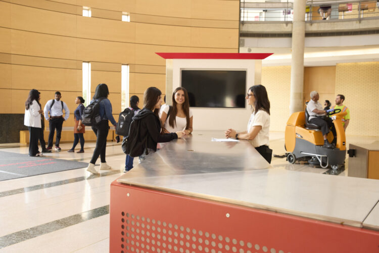 Staff and students talking in Vari Hall