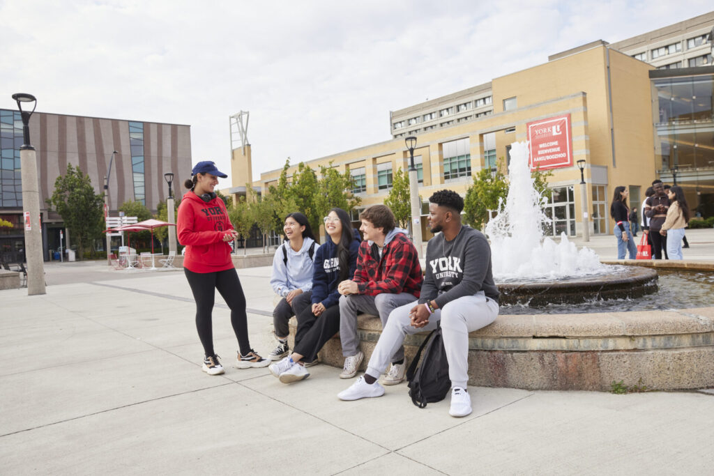 Students sitting by Vari Hall Fountain