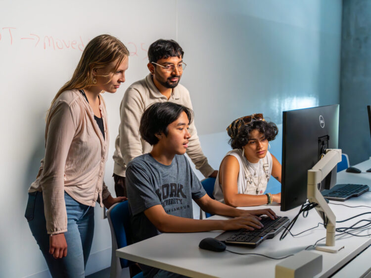 Students looking at a computer