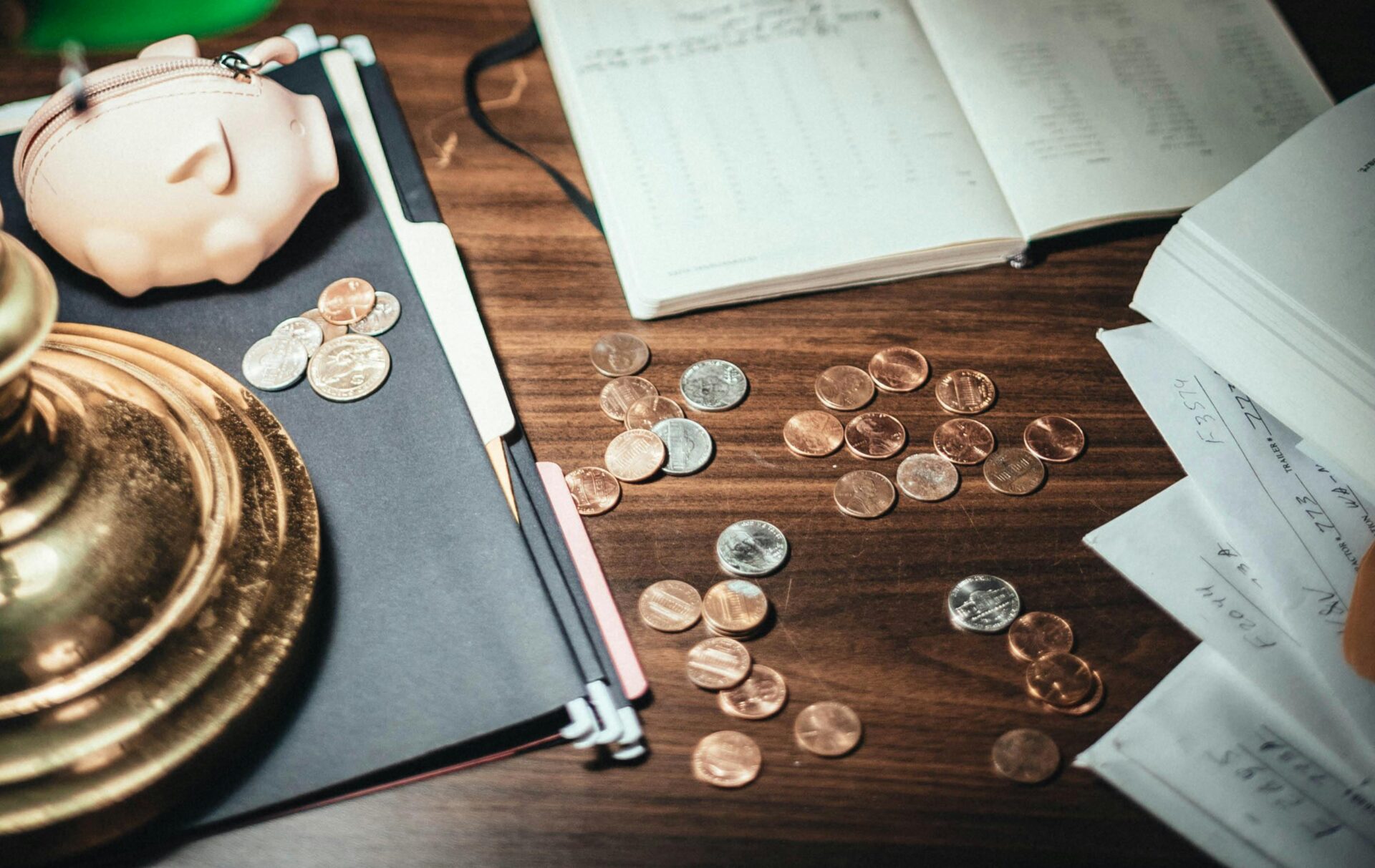 Coins scattered across a wooden surface.