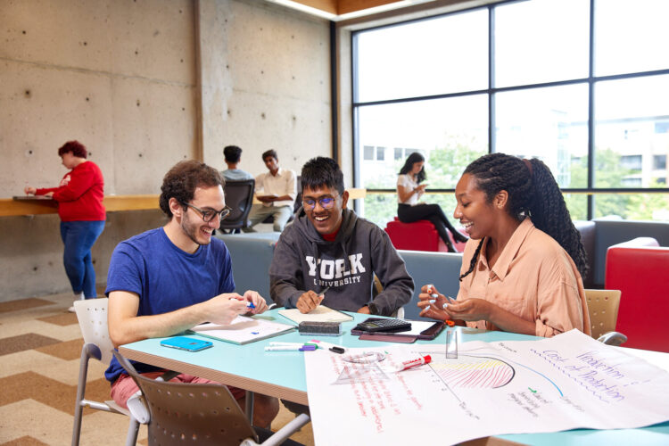Students sitting down at a table studying